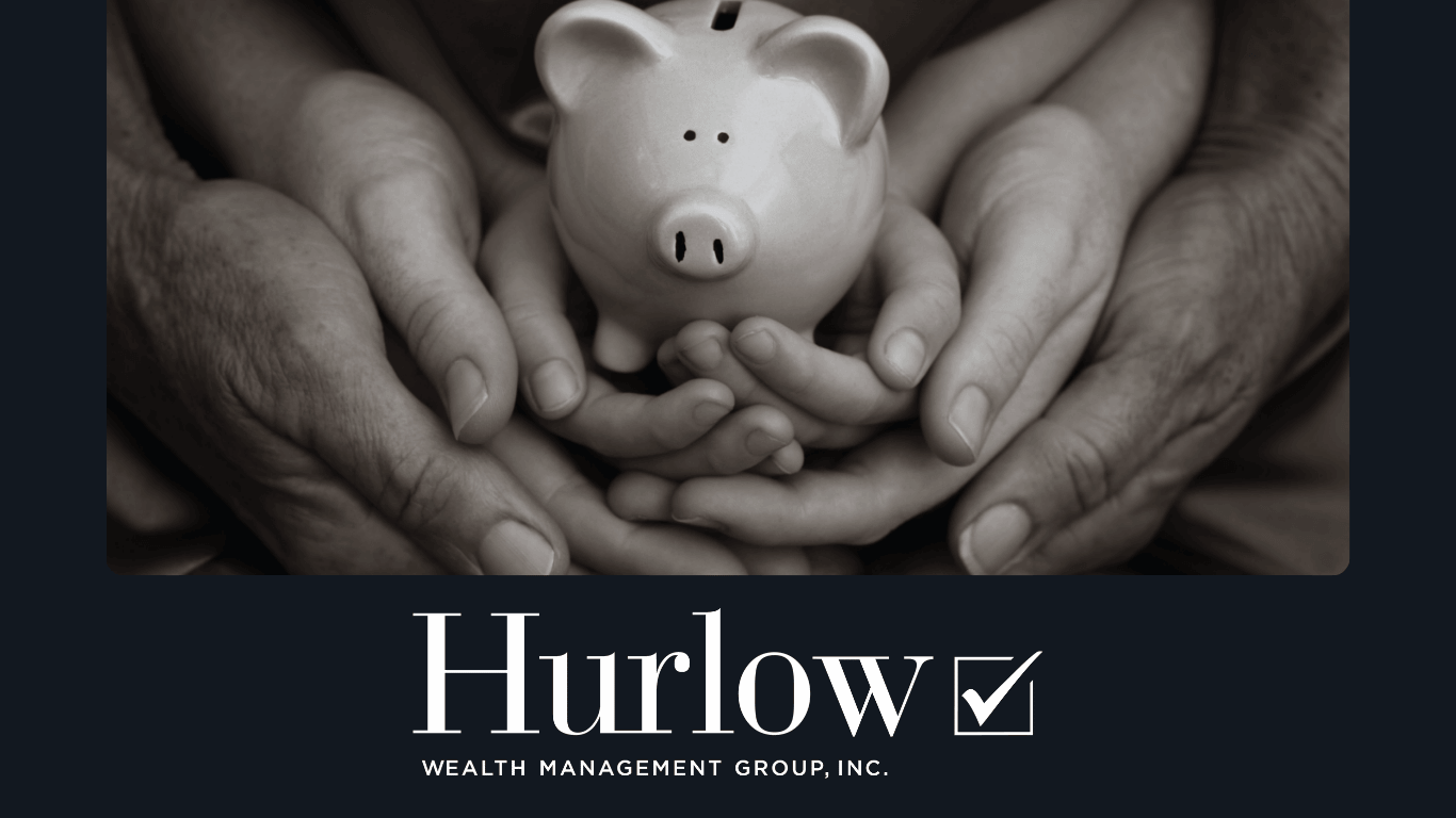 A piggy bank is held by a child's hands, surrounding by their parent's hands