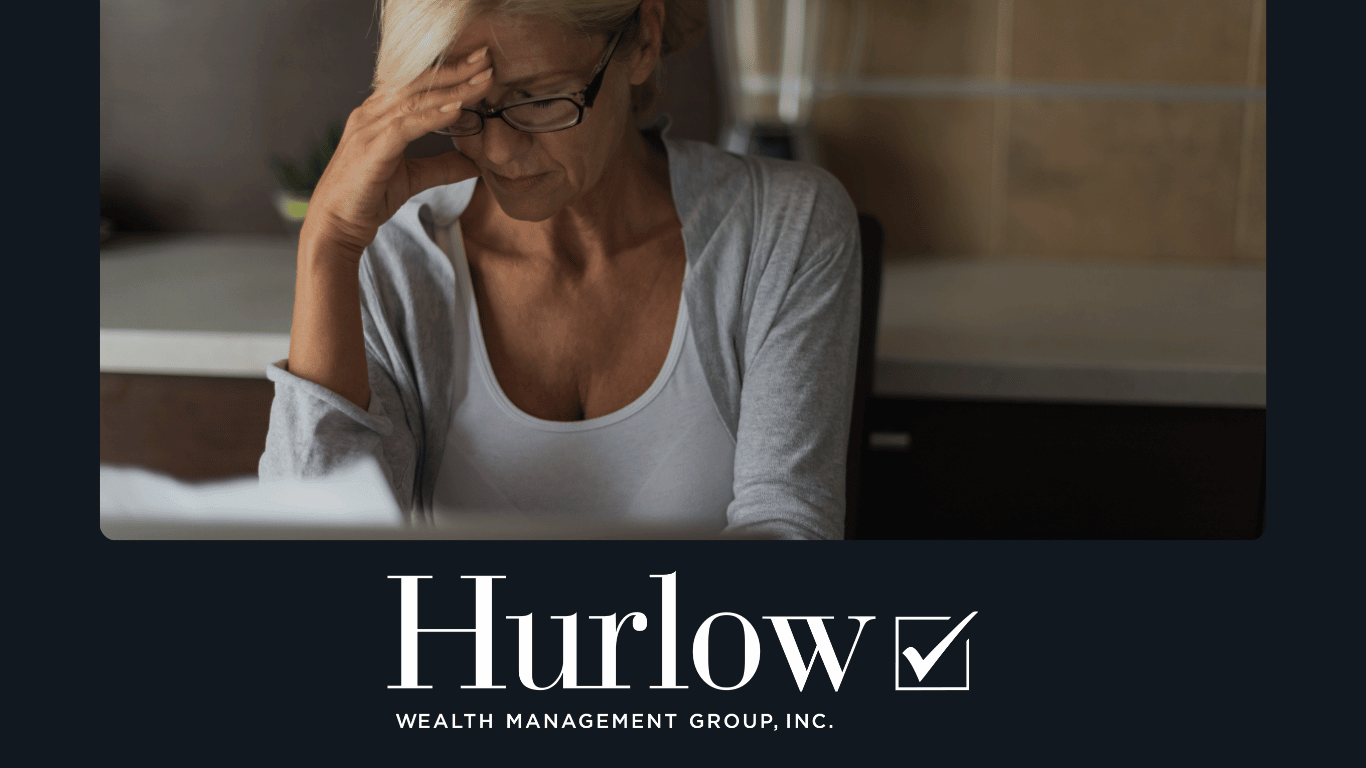 A mature lady looks stressed as she reviews a document